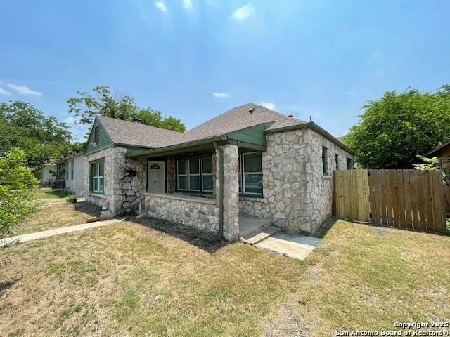 438 Vanderbilt, San Antonio, TX 78210 - view of side of home featuring stone siding and a shingled roof