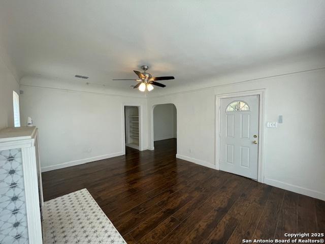 438 Vanderbilt, San Antonio, TX 78210 - unfurnished living room with ceiling fan, wood finished floors, baseboards, and arched walkways