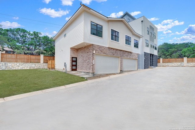 view of home's exterior featuring an attached garage, concrete driveway, stucco siding, and brick siding