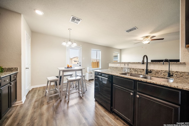 6516 Sabinal, San Antonio, TX 78252 - kitchen with dishwasher, a sink, a ceiling fan, wood finished floors, and light stone counters