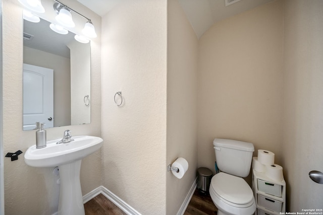 6516 Sabinal, San Antonio, TX 78252 - bathroom with wood finished floors, toilet, and baseboards