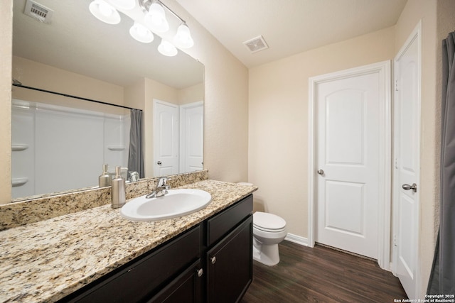 6516 Sabinal, San Antonio, TX 78252 - bathroom featuring wood finished floors, toilet, baseboards, and vanity
