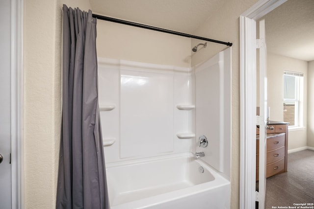 6516 Sabinal, San Antonio, TX 78252 - bathroom featuring shower / bath combo with shower curtain, vanity, a textured ceiling, and baseboards