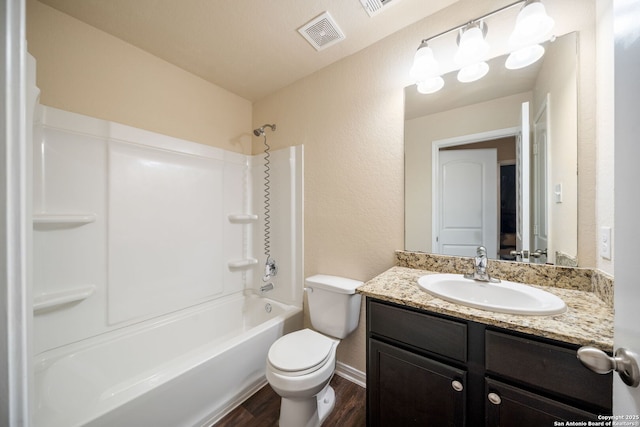 6516 Sabinal, San Antonio, TX 78252 - bathroom with wood finished floors, toilet, vanity, a textured wall, and bathing tub / shower combination