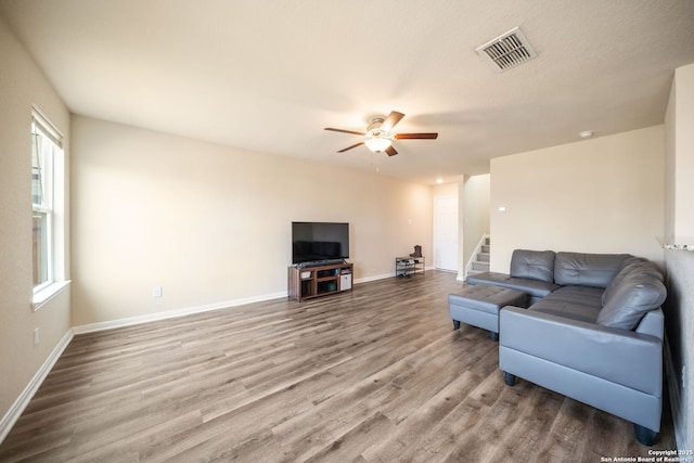 6516 Sabinal, San Antonio, TX 78252 - living room featuring ceiling fan, wood finished floors, baseboards, and stairs