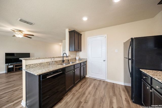 6516 Sabinal, San Antonio, TX 78252 - kitchen with black appliances, a sink, a peninsula, light wood-type flooring, and baseboards