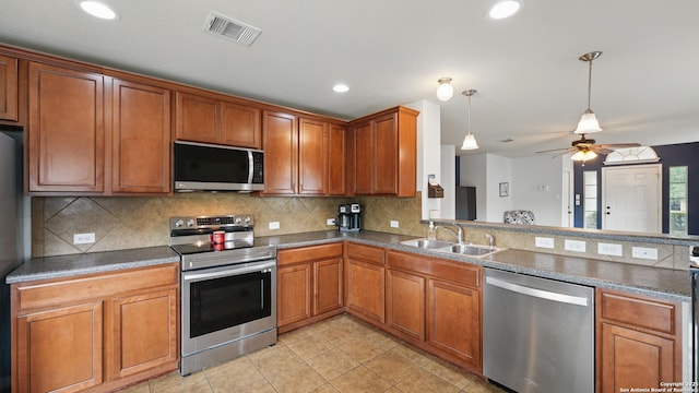 760 Guna, New Braunfels, TX 78130 - kitchen with appliances with stainless steel finishes, a sink, backsplash, light tile patterned floors, and decorative light fixtures