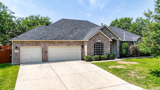 14534 Gunter Ave, San Antonio, TX 78254 - view of front facade with brick siding, an attached garage, driveway, and a shingled roof