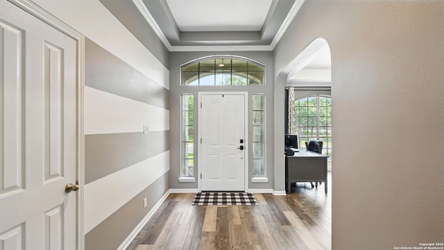 14534 Gunter Ave, San Antonio, TX 78254 - entryway featuring wood finished floors, a raised ceiling, arched walkways, baseboards, and ornamental molding