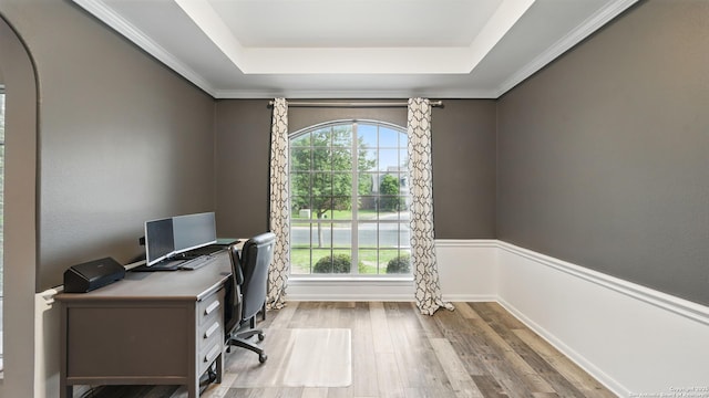 14534 Gunter Ave, San Antonio, TX 78254 - home office featuring a raised ceiling, wood finished floors, arched walkways, and a wainscoted wall