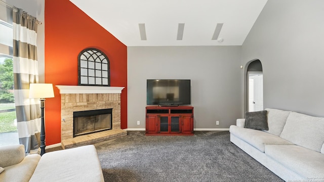 14534 Gunter Ave, San Antonio, TX 78254 - living room featuring dark colored carpet, a towering ceiling, arched walkways, a fireplace, and baseboards