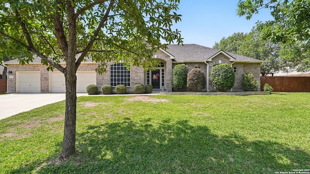 14534 Gunter Ave, San Antonio, TX 78254 - view of front of property with concrete driveway, roof with shingles, an attached garage, and brick siding