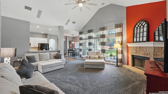 14534 Gunter Ave, San Antonio, TX 78254 - carpeted living room with a ceiling fan, high vaulted ceiling, a brick fireplace, recessed lighting, and a sink