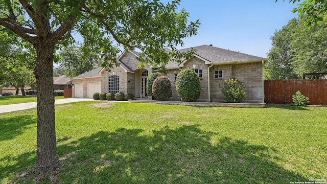 14534 Gunter Ave, San Antonio, TX 78254 - view of front of property with an attached garage, driveway, brick siding, and roof with shingles