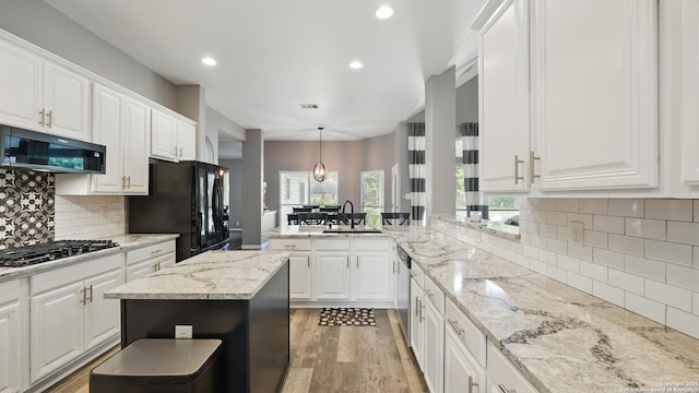14534 Gunter Ave, San Antonio, TX 78254 - kitchen with a sink, black appliances, a peninsula, recessed lighting, and white cabinets