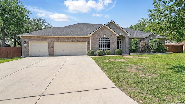 14534 Gunter Ave, San Antonio, TX 78254 - view of front of home with concrete driveway, brick siding, an attached garage, and a shingled roof
