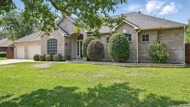14534 Gunter Ave, San Antonio, TX 78254 - view of front of home featuring a shingled roof, a garage, brick siding, and a front lawn