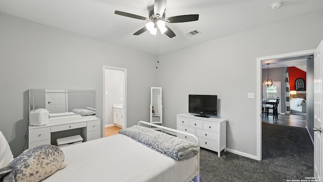 14534 Gunter Ave, San Antonio, TX 78254 - carpeted bedroom featuring baseboards, connected bathroom, ceiling fan, and a chandelier