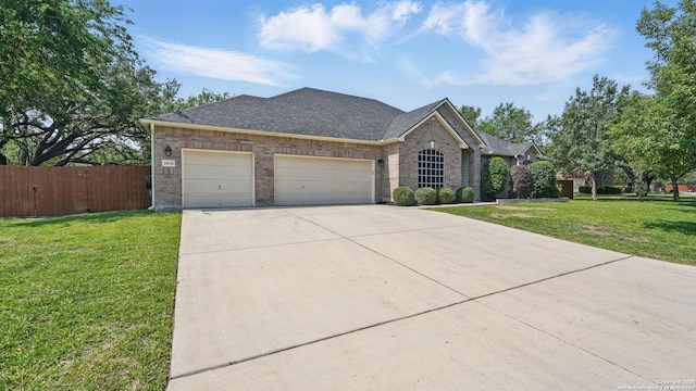14534 Gunter Ave, San Antonio, TX 78254 - view of front of home featuring a garage, driveway, brick siding, and a shingled roof