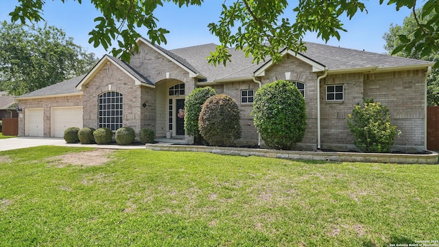 14534 Gunter Ave, San Antonio, TX 78254 - view of front of property with an attached garage, brick siding, and a front yard