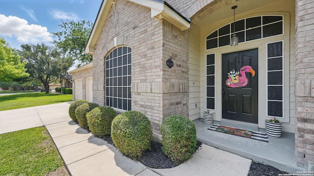 14534 Gunter Ave, San Antonio, TX 78254 - property entrance featuring brick siding, a garage, and driveway