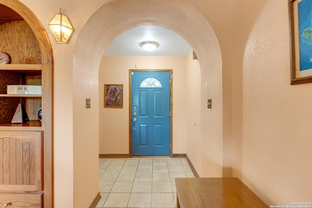 3619 Running Spgs, San Antonio, TX 78261 - foyer featuring baseboards, arched walkways, and light tile patterned floors