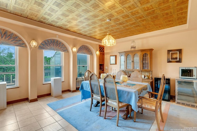 3619 Running Spgs, San Antonio, TX 78261 - dining area featuring an ornate ceiling, a chandelier, wine cooler, light tile patterned flooring, and baseboards