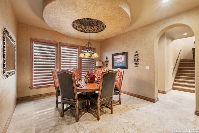 44 Oakland, Boerne, TX 78006 - dining area with arched walkways, stairs, a chandelier, baseboards, and a textured wall