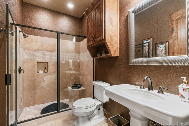 44 Oakland, Boerne, TX 78006 - full bath with toilet, a textured wall, a shower stall, and a sink