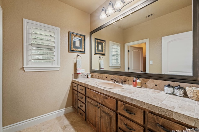 44 Oakland, Boerne, TX 78006 - bathroom featuring vanity, baseboards, and a textured wall