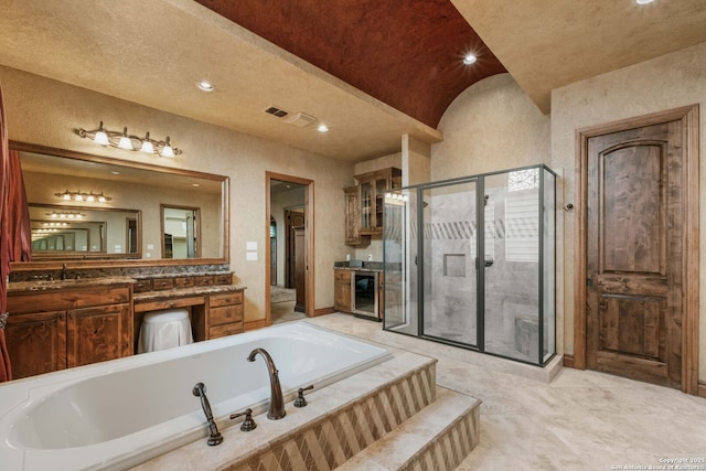 44 Oakland, Boerne, TX 78006 - bathroom with a garden tub, a shower stall, vanity, beverage cooler, and recessed lighting