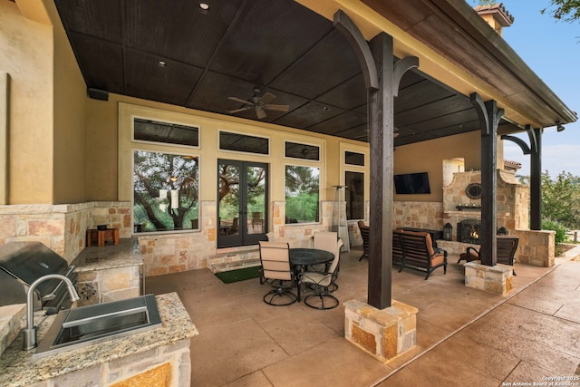 44 Oakland, Boerne, TX 78006 - view of patio / terrace with an outdoor stone fireplace, french doors, a sink, exterior kitchen, and ceiling fan