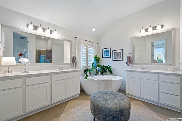 1235 Yaupon, New Braunfels, TX 78132 - bathroom with lofted ceiling, a freestanding bath, vanity, a shower with door, and recessed lighting