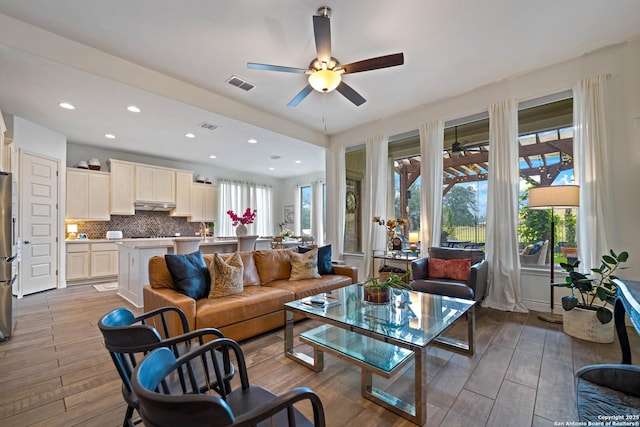 1235 Yaupon, New Braunfels, TX 78132 - living area featuring ceiling fan, plenty of natural light, wood finished floors, and recessed lighting