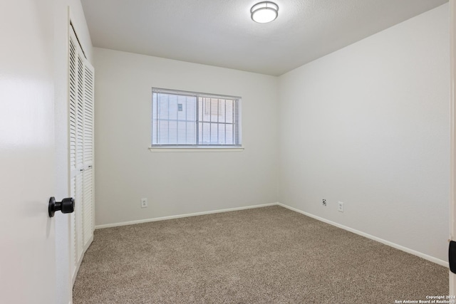 1102 Fillmore Dr, San Antonio, TX 78245 - unfurnished bedroom with a closet, carpet flooring, and baseboards
