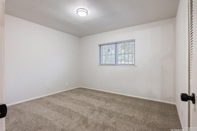 1102 Fillmore Dr, San Antonio, TX 78245 - spare room featuring carpet flooring, baseboards, and a textured ceiling