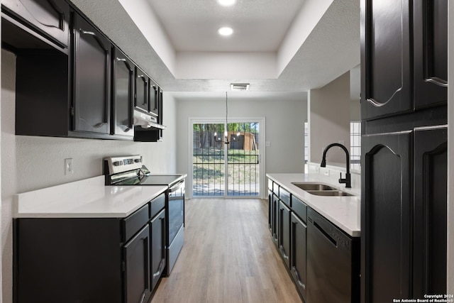 1102 Fillmore Dr, San Antonio, TX 78245 - kitchen featuring appliances with stainless steel finishes, a sink, under cabinet range hood, dark cabinets, and light countertops