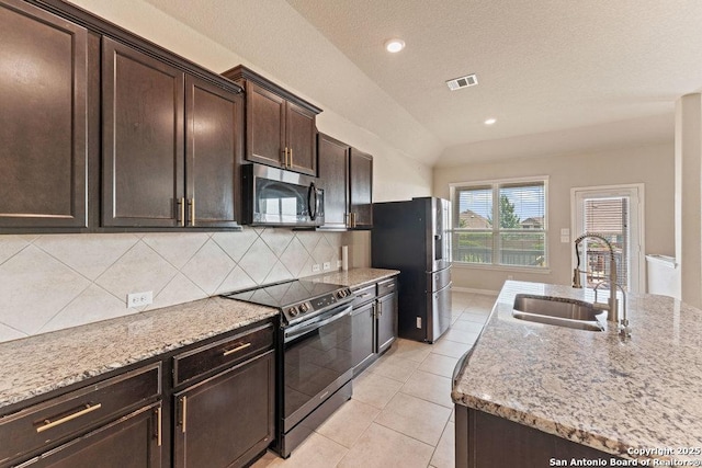 2317 Broken Wheel Ln, New Braunfels, TX 78130 - kitchen with appliances with stainless steel finishes, a sink, backsplash, light stone counters, and recessed lighting