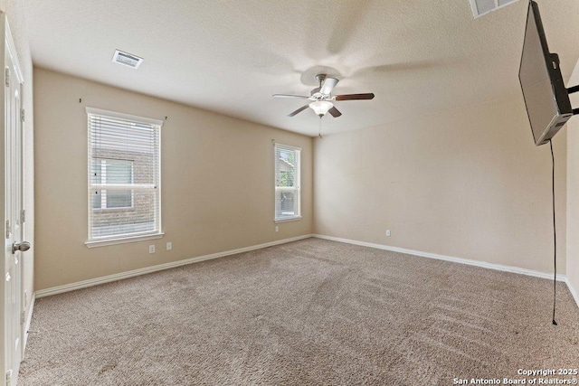 2317 Broken Wheel Ln, New Braunfels, TX 78130 - carpeted spare room featuring a ceiling fan, baseboards, and a textured ceiling