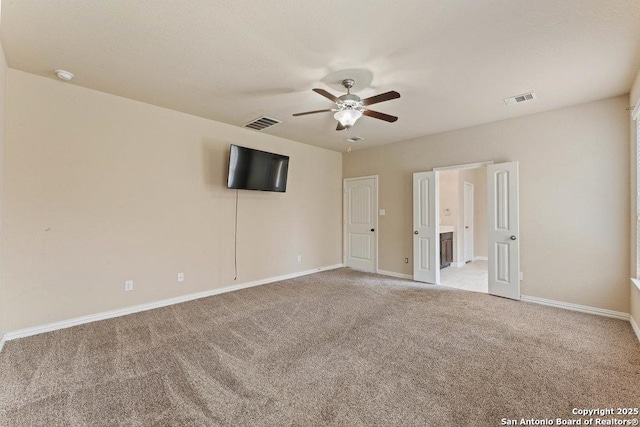 2317 Broken Wheel Ln, New Braunfels, TX 78130 - unfurnished bedroom with light colored carpet, baseboards, a ceiling fan, and ensuite bath