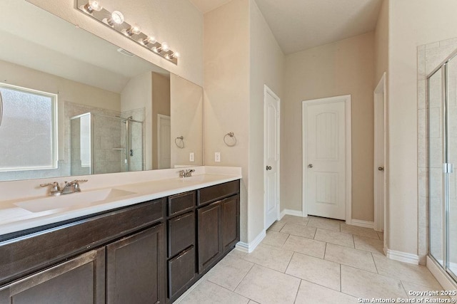 2317 Broken Wheel Ln, New Braunfels, TX 78130 - bathroom featuring a shower stall, double vanity, tile patterned floors, and baseboards