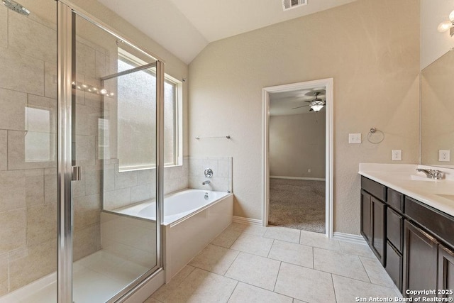 2317 Broken Wheel Ln, New Braunfels, TX 78130 - full bathroom with lofted ceiling, ceiling fan, a stall shower, a garden tub, and tile patterned floors