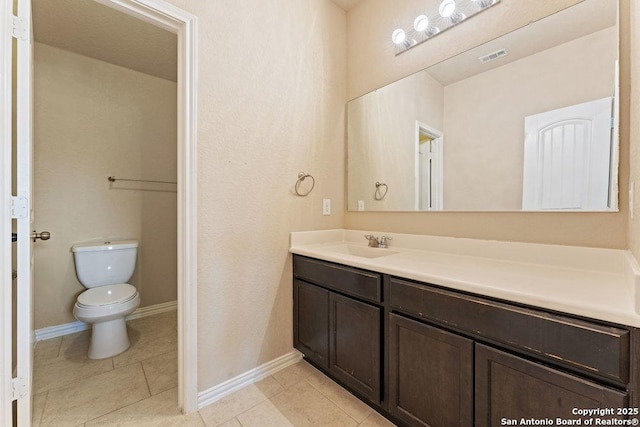 2317 Broken Wheel Ln, New Braunfels, TX 78130 - bathroom featuring vanity, toilet, tile patterned floors, and baseboards