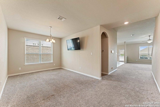 2317 Broken Wheel Ln, New Braunfels, TX 78130 - carpeted empty room with ceiling fan, a chandelier, baseboards, and a textured ceiling