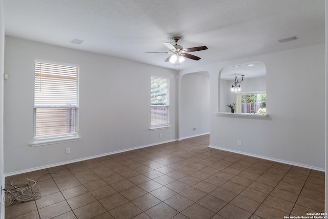 175 Katherine Way, San Antonio, TX 78253 - empty room featuring arched walkways, a ceiling fan, baseboards, and tile patterned floors
