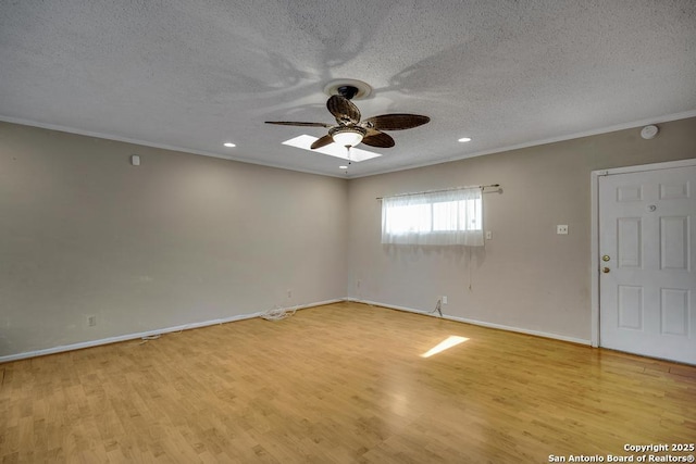 338 Tango Dr, San Antonio, TX 78216 - empty room with ornamental molding, a ceiling fan, a textured ceiling, light wood finished floors, and baseboards