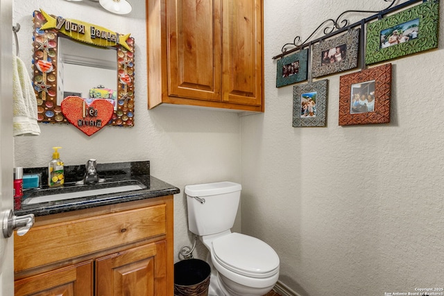 381 Schneider Rd, Seguin, TX 78155 - half bath featuring vanity, toilet, and a textured wall
