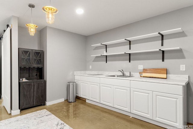 381 Schneider Rd, Seguin, TX 78155 - bar with a sink, concrete floors, pendant lighting, baseboards, and a barn door