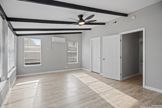 7626 Westfield, San Antonio, TX 78227 - unfurnished bedroom with multiple windows, an AC wall unit, baseboards, beam ceiling, and light wood-style floors
