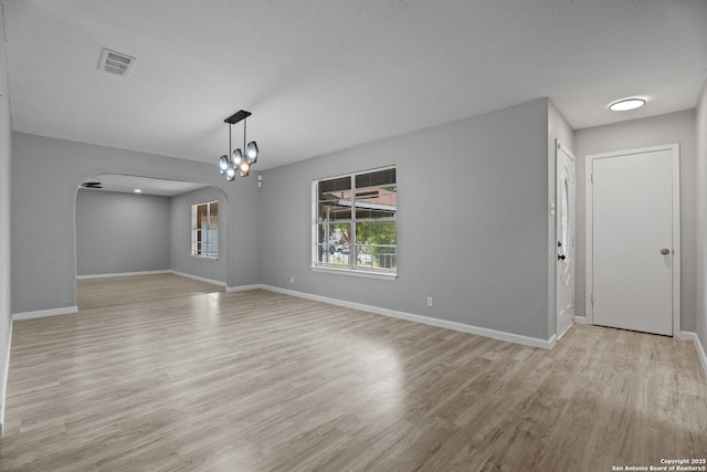 7626 Westfield, San Antonio, TX 78227 - empty room with arched walkways, light wood-style flooring, and baseboards
